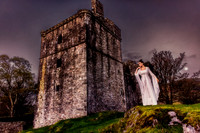 Coloe Fine Art photo of a woman in a white gown, posed in front of a Scottish castle.