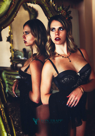 Fashion-glamour photo of a blonde beauty in lingerie informs of a mirror in a Venetian palazzo.