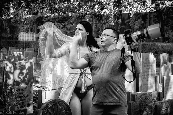 Behind the Scenes photo taken in Naarden Holland of a photographer and assistant photographing a woman in lingerie outdoors.