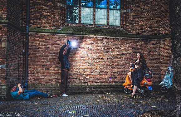 Behind the Scenes photo taken in Naarden Holland of a photographer and assistant photographing a woman in lingerie outdoors.
