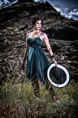 Color fashion photo of a woman in a dress posed on the high Texas desert.