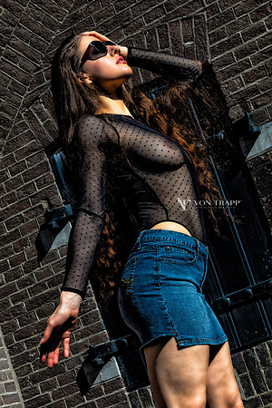 Glamour photo of a Dutch beauty outside in a sheer bodysuit and mini skirt, Naarden Vesting, Holland