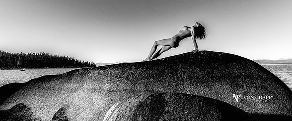 Black and White fine art nude photo of a woman on a huge bolder in Lake Tahoe.