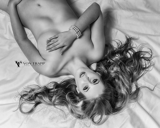 Art-glamour nude of a hot blonde posed nude on the floor.
