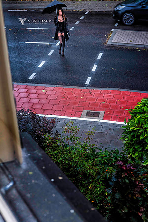 Sexy woman wearing lingerie walking in public on a street in Gouda, Holand.