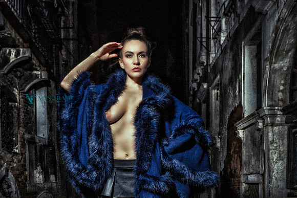 Edgy fashion-glamour photo of a topless woman taken at night in Venice, Italy.