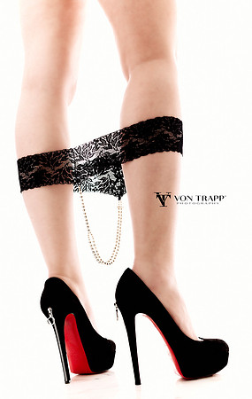 Alluring boudoir photo of a woman in stilettoed pumps and a pearl thong.