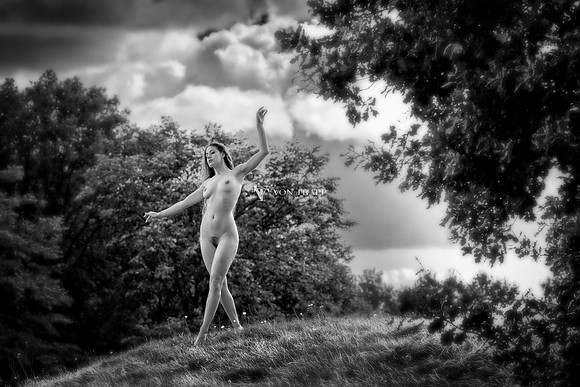 Art nude photo of a sexy Dutch woman posed on a grassy hill in Naarden Vesting, Holland.
