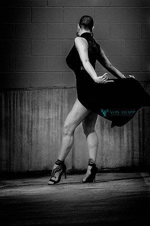 Photo of a sexy and busty mature woman lifting up her dress in a fashion-glamour photograph.
