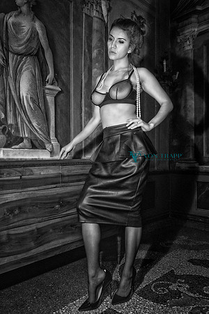 Fashion-Glamour photo of a hot busty woman in a sheer bra and pencil skirt in a Venetian palazzo.