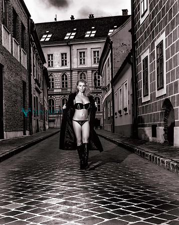 Photo taken in Budapest of a sexy busty mature woman in a long coat, flashing her lingerie in public.