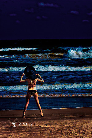 Fine Art photo of a woman in a bikini and broad brim hat on a Texas beach.