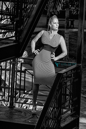 Fashion photo of a lovely woman in a tight dress outdoors.