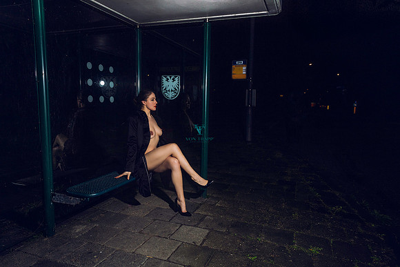 Sexy nude Dutch model in a trench coat and heels, flashing at a bus stop.