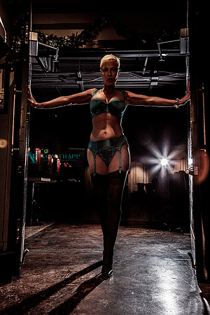 Fashion-glamour photo of a stunning mature woman in lingerie at a bar in San Antonio Texas.