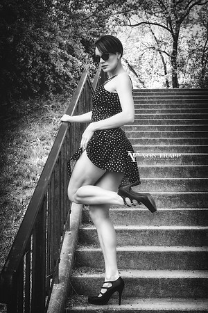 Glamour photo of a leggy woman lifting up her dress.