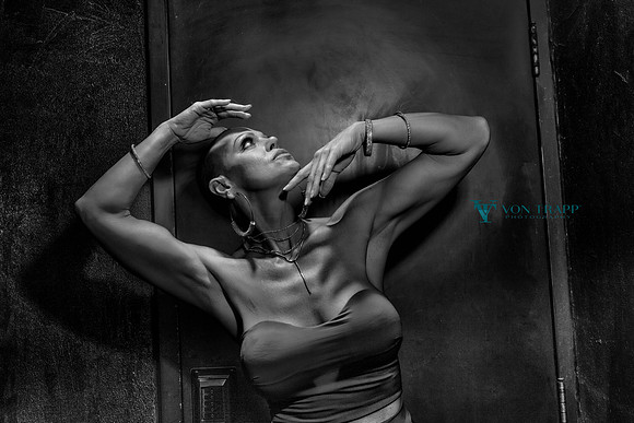 Edgy fashion glamour photo of a busty woman.