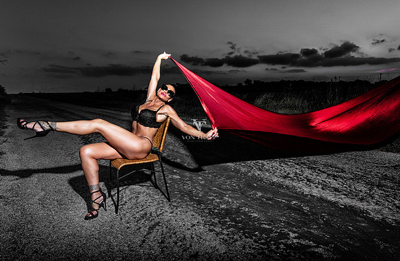 Fashion Glamour photo of a chesty bald woman outdoors on a road in lingerie.