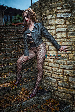 Photo of a hot woman outdoors wearing fashion tights, bustier, stilettoes and a crowed jacket.