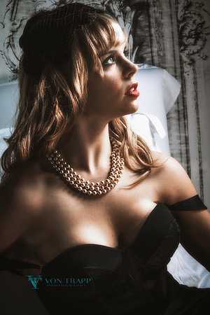 Fashion Glamour photograph of a woman in a low-cut dress.