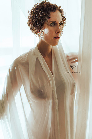 Sexy art nude photo of a busty woman covered in sheer white fabric. Nipples and big boobs.