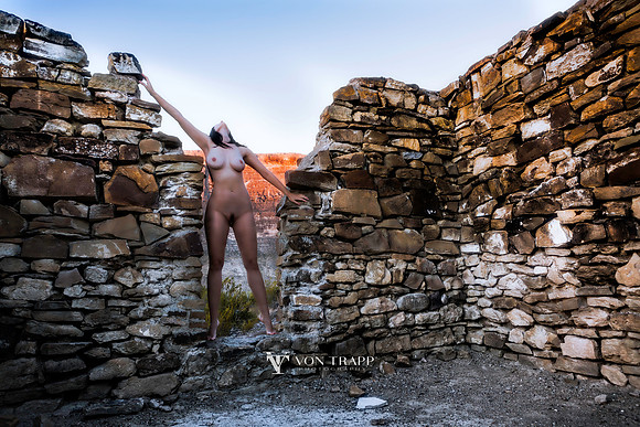 Art nude photograph of a sexy woman in a doorway of a 1800's stone building in the Texas desert.
