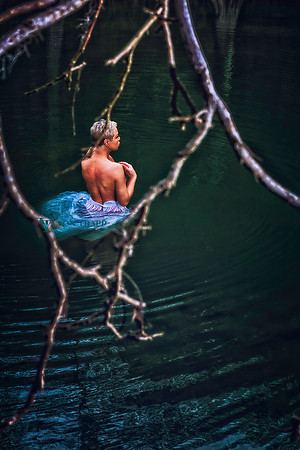 Art nude photo of a woman. in a stream.