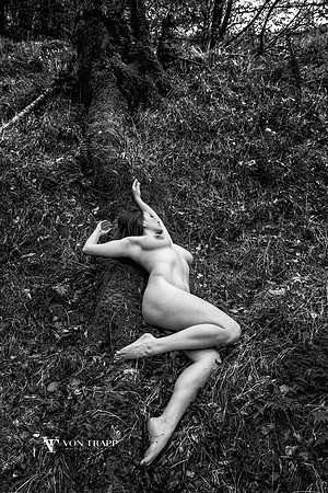 Art nude photo of a busty woman in the English Lake District.