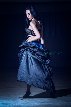 Lingerie Glamour photograph of a sexy woman in a long coat and lingerie posed in a parking garage in San Antonio.