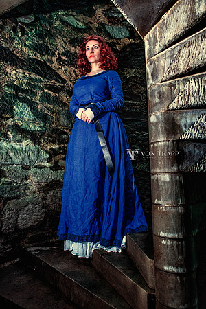 Fine art color photo created in a Scottish castle of a hot redhead in period costume.