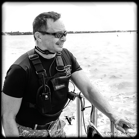 Photo of a man wearing throat mic communications.