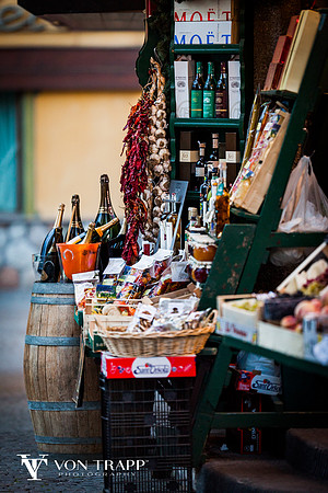 Vendor stand, elegantly displaying fruits, wine, Champaign and other delectables of the region. Travel photograph by Austin/Houston/San Antonio Glamour Photographer Richard von Trapp.