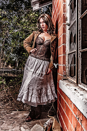 Edgy glamour portrait of a woman in a skirt and bustier.