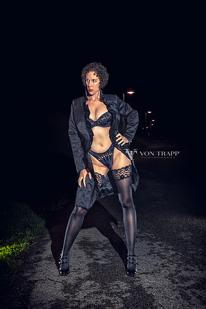 Nighttime lingerie glamour photo of a hot woman flashing outdoors in Cortina, Italy.