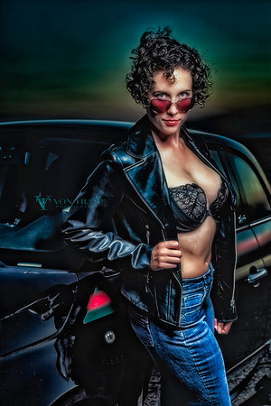 Fashion Glamour photograph of a busty beauty in a lace bra and leather jacket, flashing outdoors in west Texas.