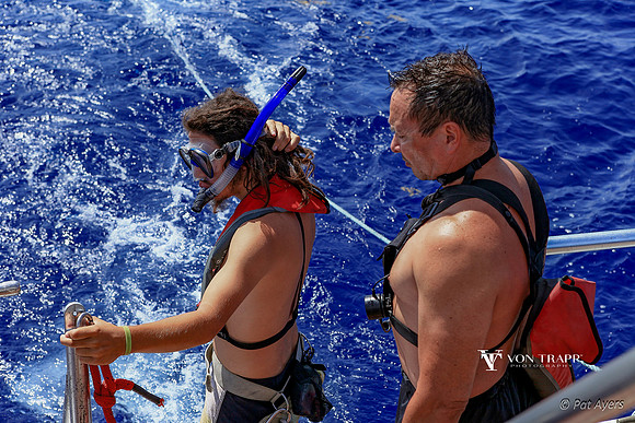 Photo of a diver and Divemaster on the back deck of a boat.