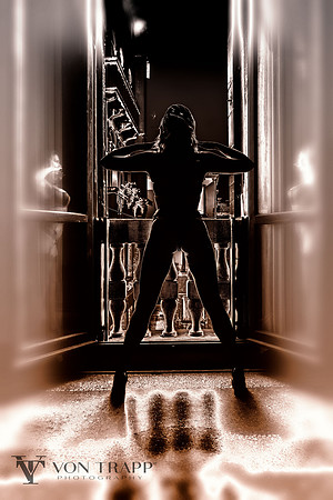 Fashion image of woman at the doorway to a Venice Palazzo balcony wearing lingerie.