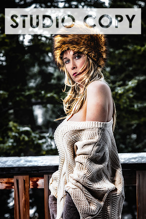 Coloe glamour photo of a hot blonde flashing while outdoors in the snow.