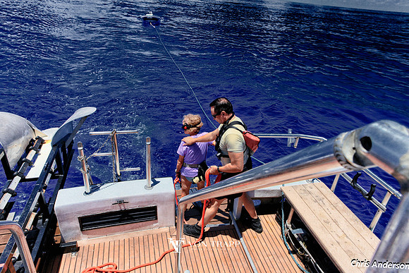 Photo of a diver and Divemaster on the back deck of a boat.