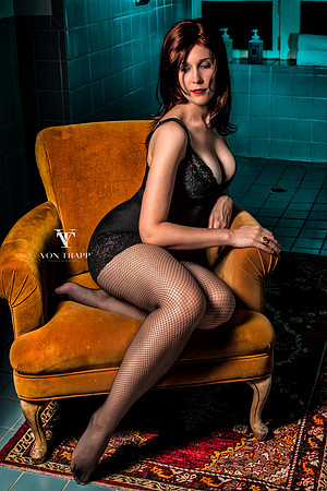 Lingerie glamour photo of a sexy woman posed sitting on a chair. San Antonio Glamour Photography,