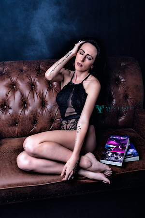 Boudoir photo of a sexy woman in lingerie on a sofa.