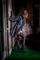 Glamour photo of a hot woman in a long coat, flashing her stocking tops.